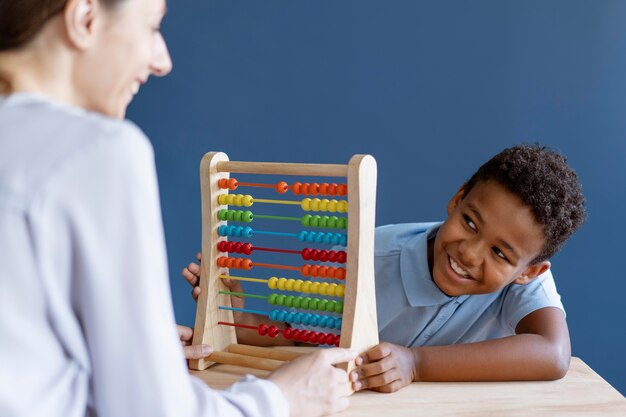 Little boy having an occupational therapy session with a psychologist