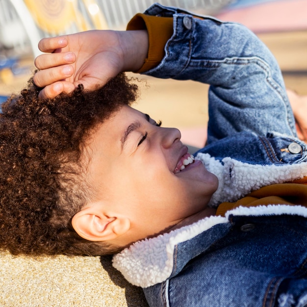 Little boy hiding his face from the sun