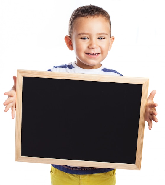 Little boy holding a blackboard