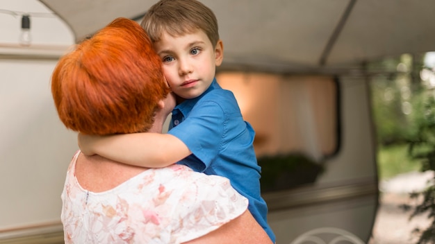 Free photo little boy hugging his grandmother