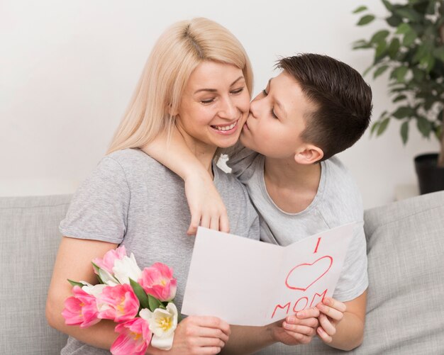 Little boy kissing his mother