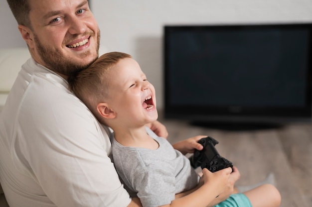 コントローラーで遊んでいる間笑う少年