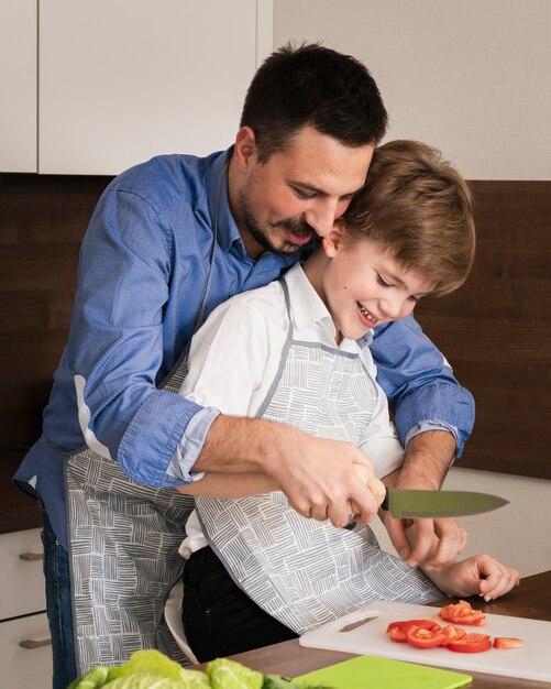 Little boy lesson in kitchen with father