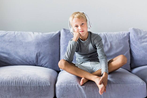 Little boy listening music at home