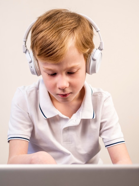 Little boy listening to music through headphones