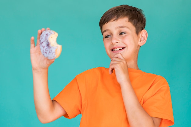 Little boy looking at a doughnut