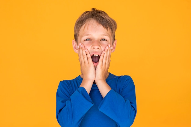 Free photo little boy looking shocked