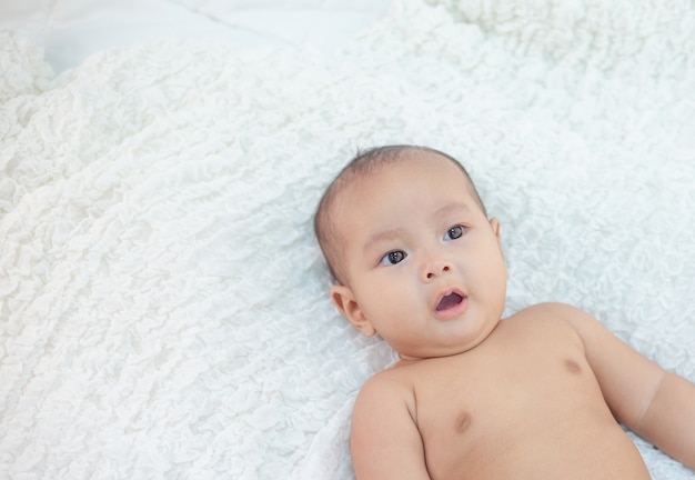 A little boy lying in the bed