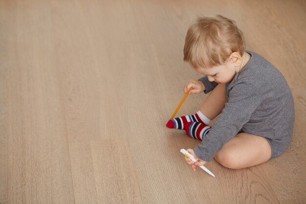 Little boy lying on the floor in the living room