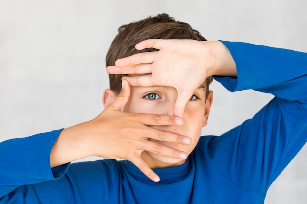 Little boy making a frame with his fingers