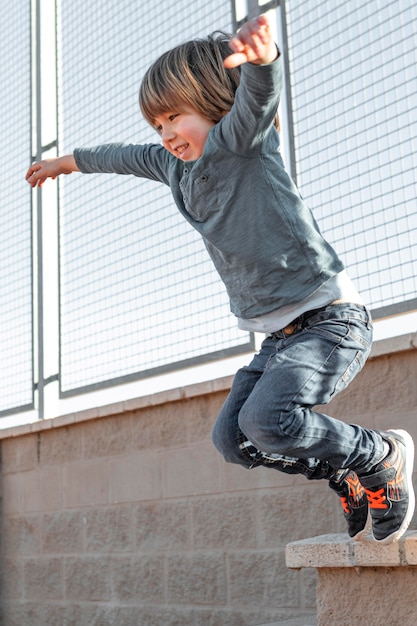 little boy outdoors jumping