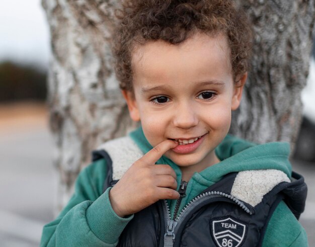little boy outdoors smiling
