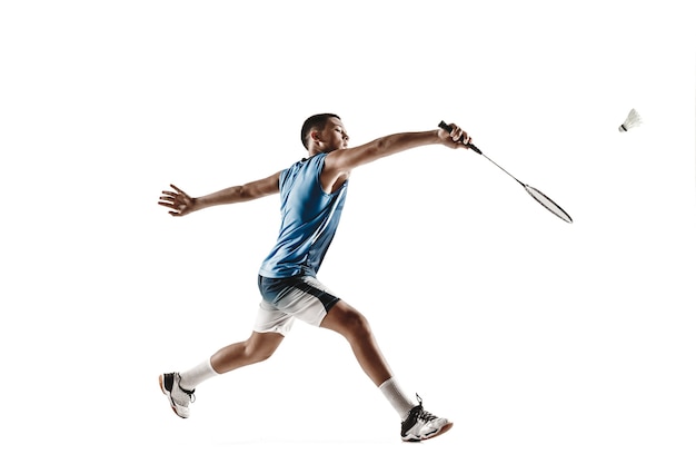 Little boy playing badminton isolated on white  wall