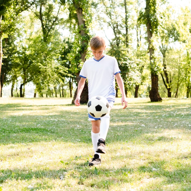 Little boy playing football