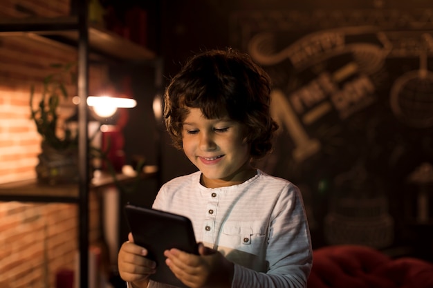 Little boy playing on his tablet