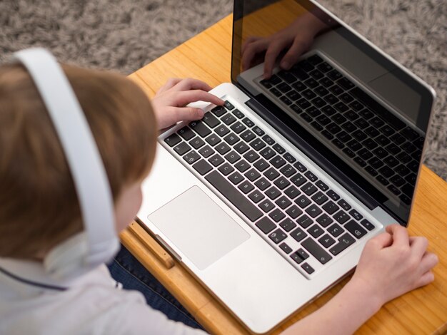 Little boy playing on laptop