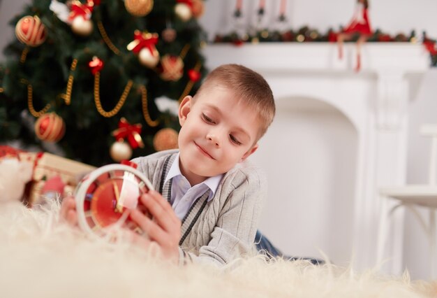 Little boy playing with a clock