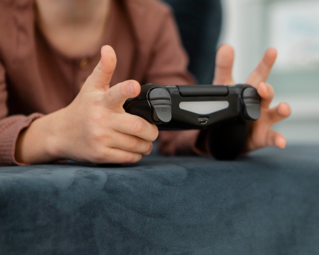 Free photo little boy playing with a controller