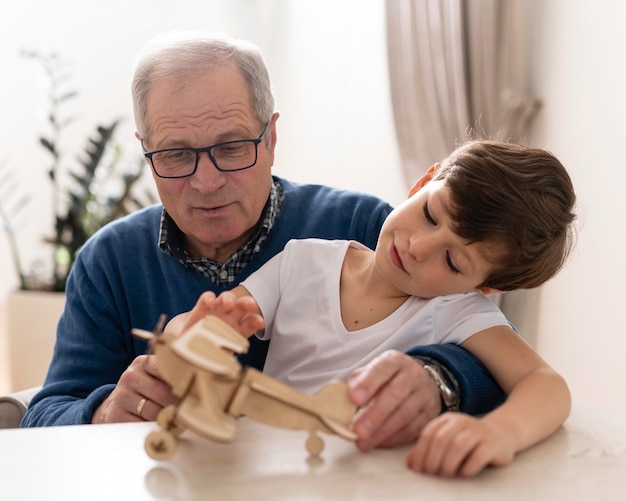 Little boy playing with his grandfather