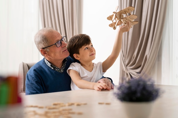 Little boy playing with his grandfather
