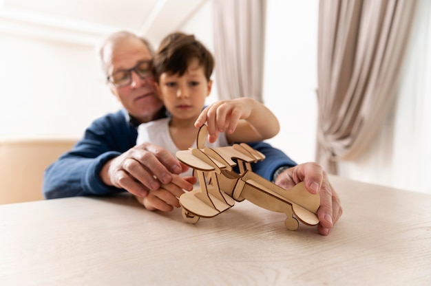 Little boy playing with his grandfather