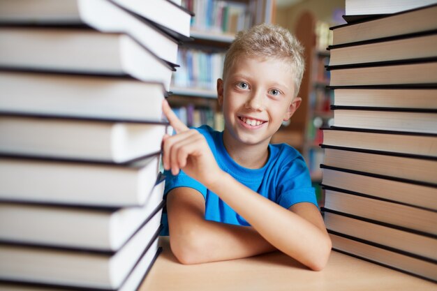 Little boy pointing a book