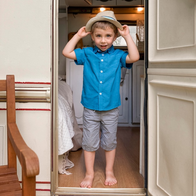 Little boy putting a cute hat on