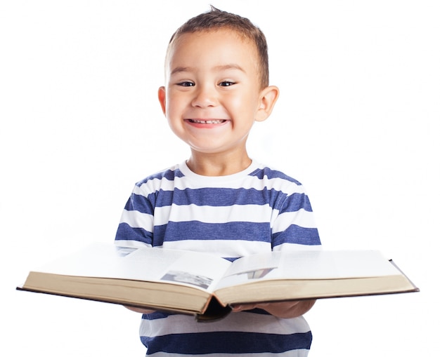 Free photo little boy smiling with a book