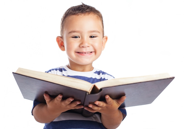 Little boy smiling with an open book