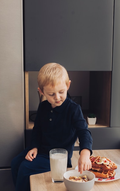 Little boy taking cereals