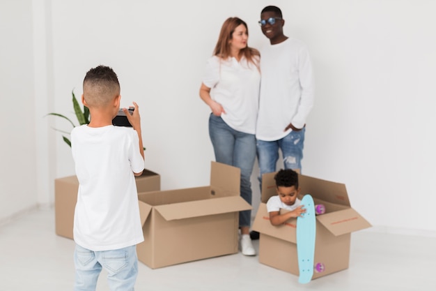 Little boy taking a photo of his family