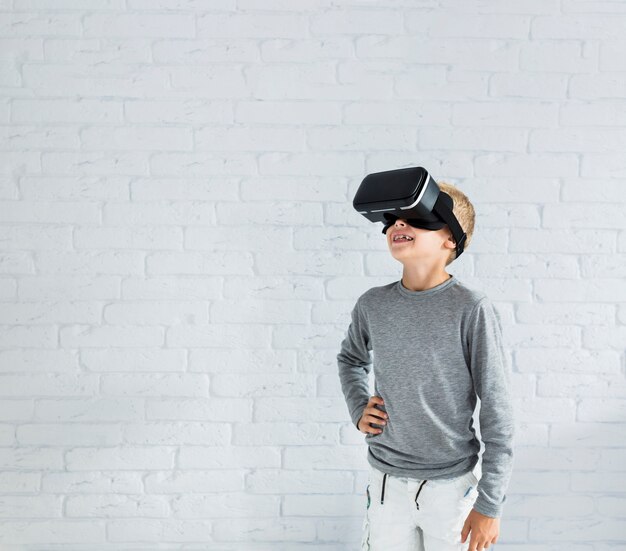 Little boy using virtual reality glasses