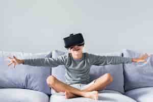 Free photo little boy using virtual reality glasses