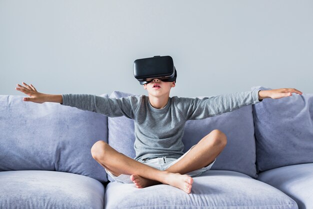 Free photo little boy using virtual reality glasses