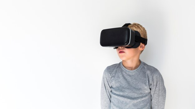 Little boy using virtual reality glasses
