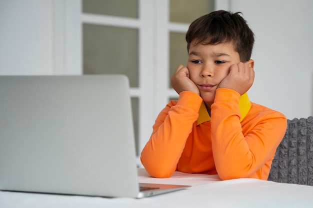 Little boy watching films on laptop