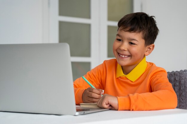 Little boy watching films on laptop