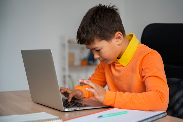 Little boy watching films on laptop