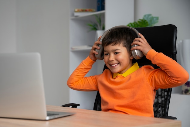 Little boy watching films on laptop