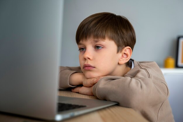 Little boy watching films on the laptop