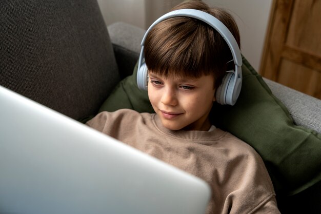 Little boy watching films on the laptop
