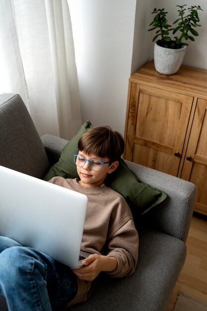 ラップトップで映画を見ている少年