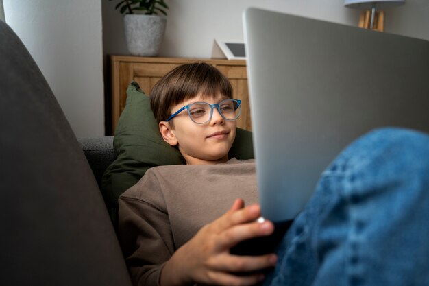 Little boy watching films on the laptop