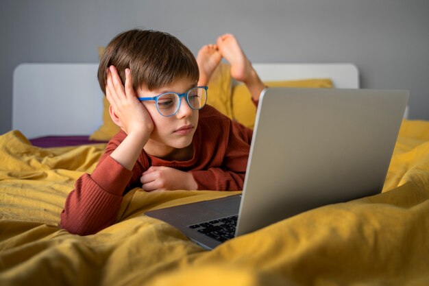 Little boy watching films on the laptop