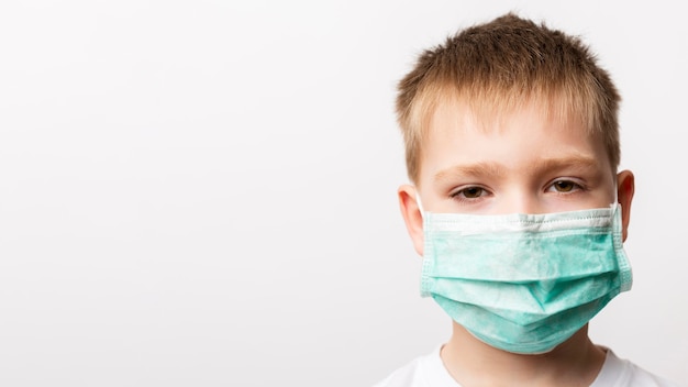 Little boy wearing medical mask