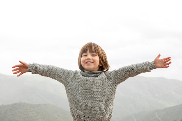 Free photo little boy with arms opened