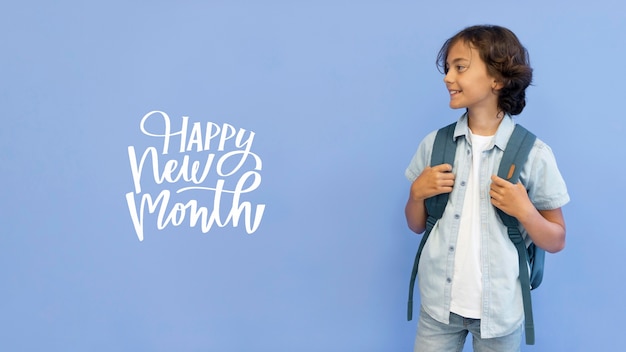 Free photo little boy with happy new month lettering