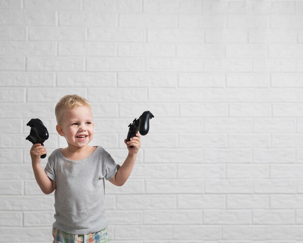 Little boy with joystick in hands copy-space