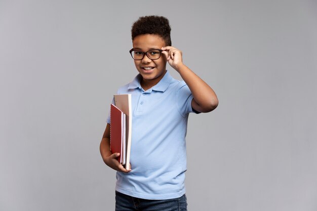 little boy with notebooks