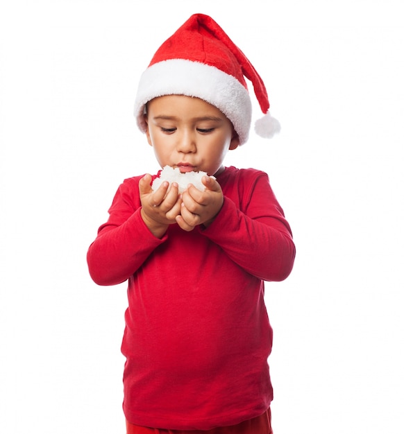 Free photo little boy with snow in hands